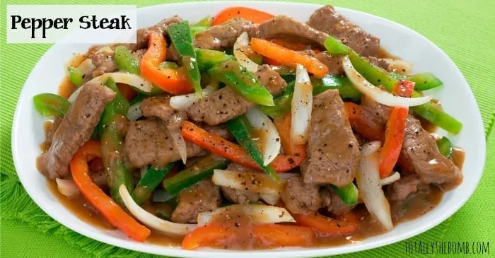 pepper steak piled into a bowl on a green tablecloth 