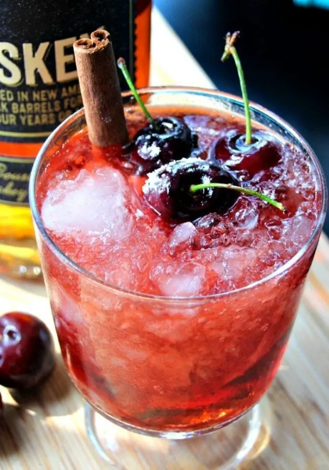 garnished with cherries and a cinnamon stick, this whiskey bourbon gherry bomb is a light and freshing cocktail