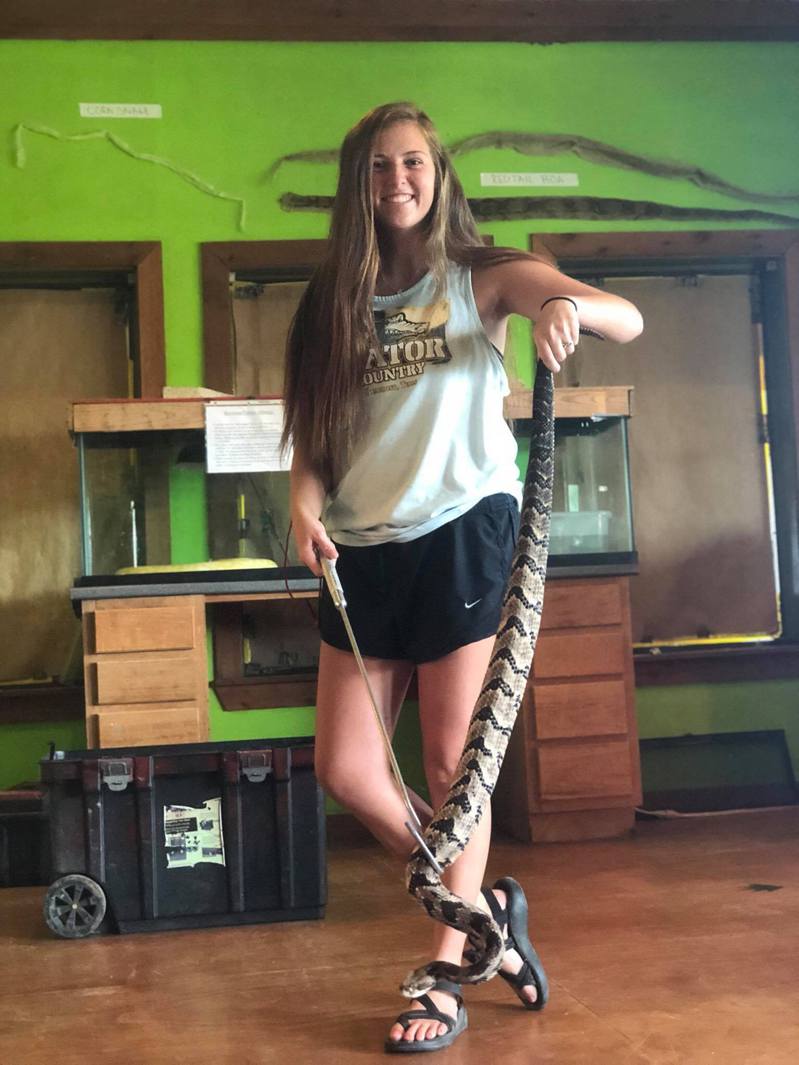girl playing with a rattlesnake