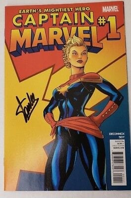 Signed copy of Captain Marvel Comic on a table.