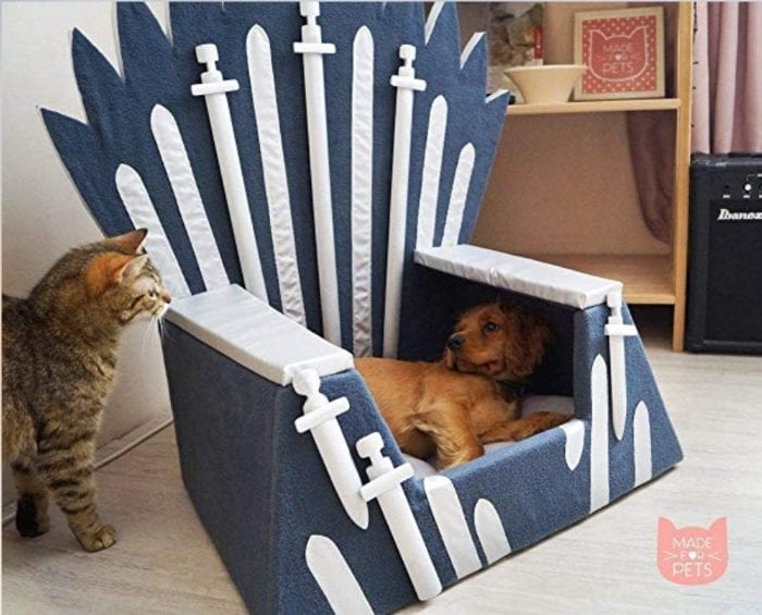 Dog bed with fake swords on it made to look like the iron throne from Game of Thrones.