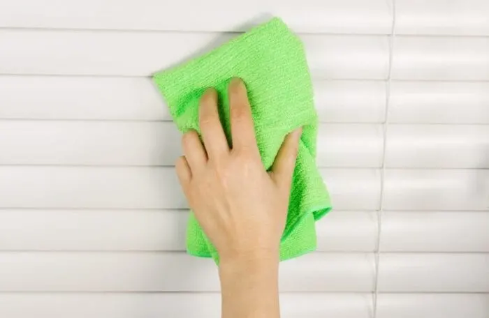 cleaning blinds with microfiber towel