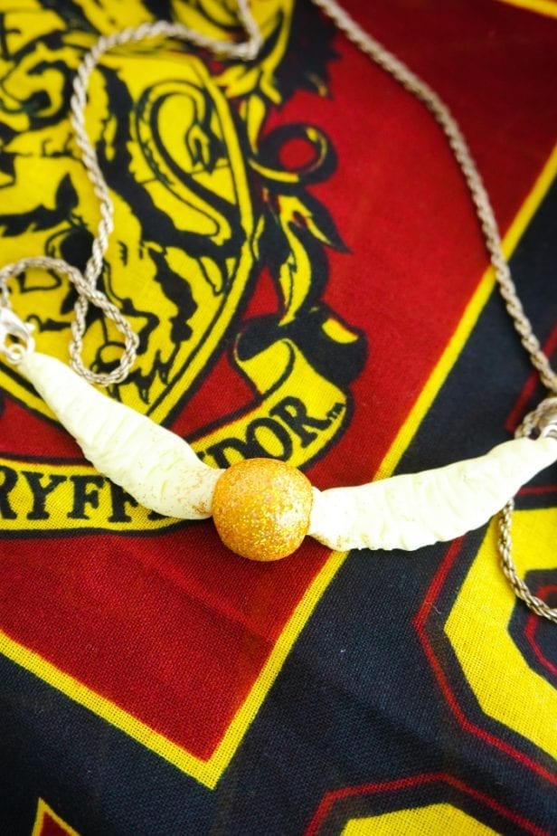 Seriously, I can't believe I caught it! Dude, this DIY Snitch Necklace is made to be Chased (and worn)! And it's so easy. #harrypotter #snitch #snitchnecklace #diyharrypotterjewelry #harrypotterjewelry #snitchjewelry