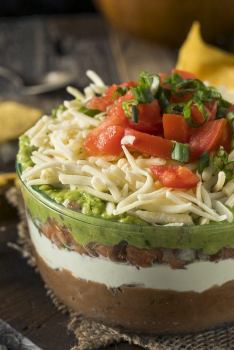 Homemade chunky 7 Layer Dip with Beans, Sour Cream and Guacamole