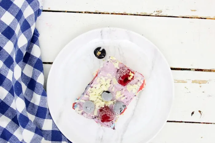 a slice of no bake cheesecake on a plate with berries