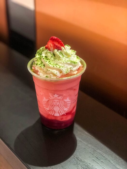 The Cindy Lou Who Drink is a blended strawberry lemonade topped with whipped cream and dusted with macha powder