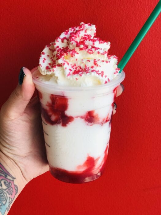 this Santa Claus Frappuccino is made with a vanilla bean frappe with strawberries