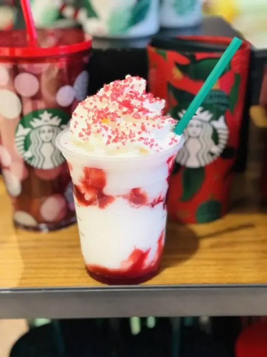 the Santa Claus Frappuccino is a vanilla bean frappuccino with strawberries and whipped cream topped with red sugar