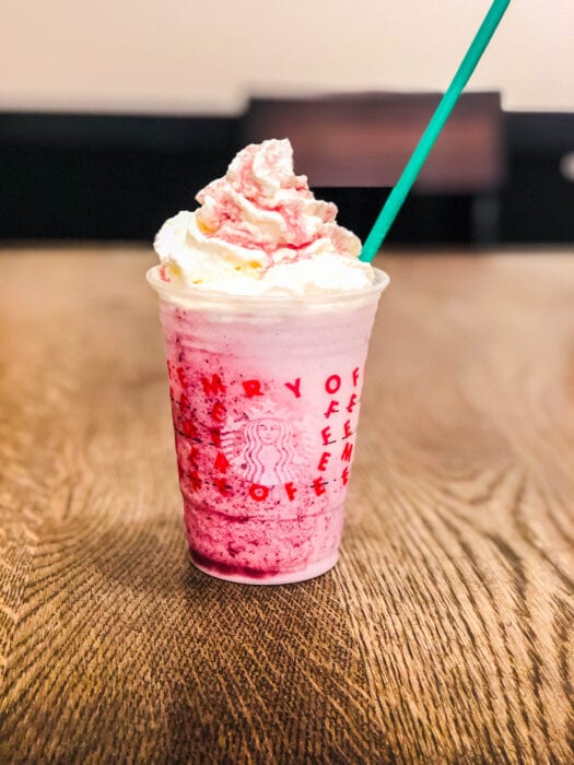 this Frozen themed Starbucks Frappuccino has blueberry infused whipped cream
