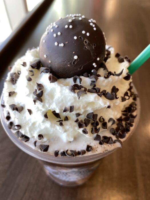 The New Years Ball Drop Frappuccino is topped with a tasty chocolate cake pop