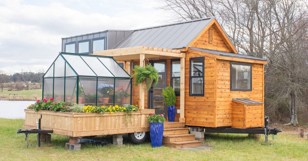 This Tiny House Comes Complete With A Porch and Greenhouse Making It A Gardener’s Dream