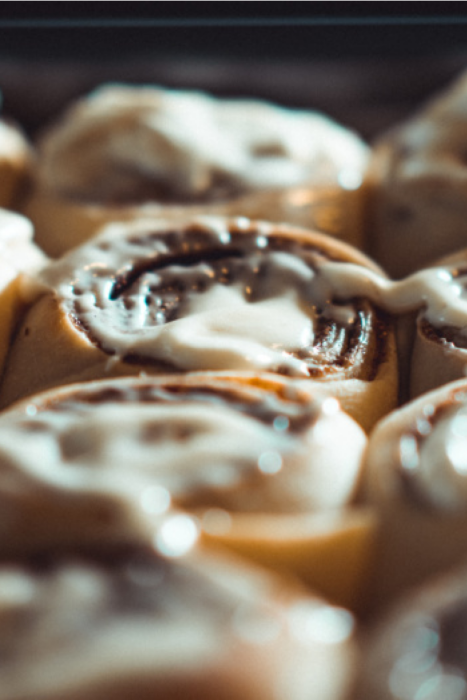 This image has an empty alt attribute; its file name is cinnamon-rolls-in-the-oven--467x700.png