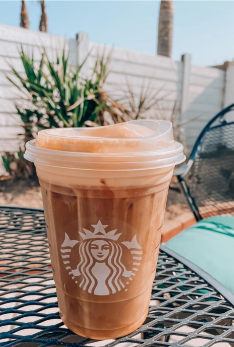 pumpkin cream cold brew in a starbucks cup on a table