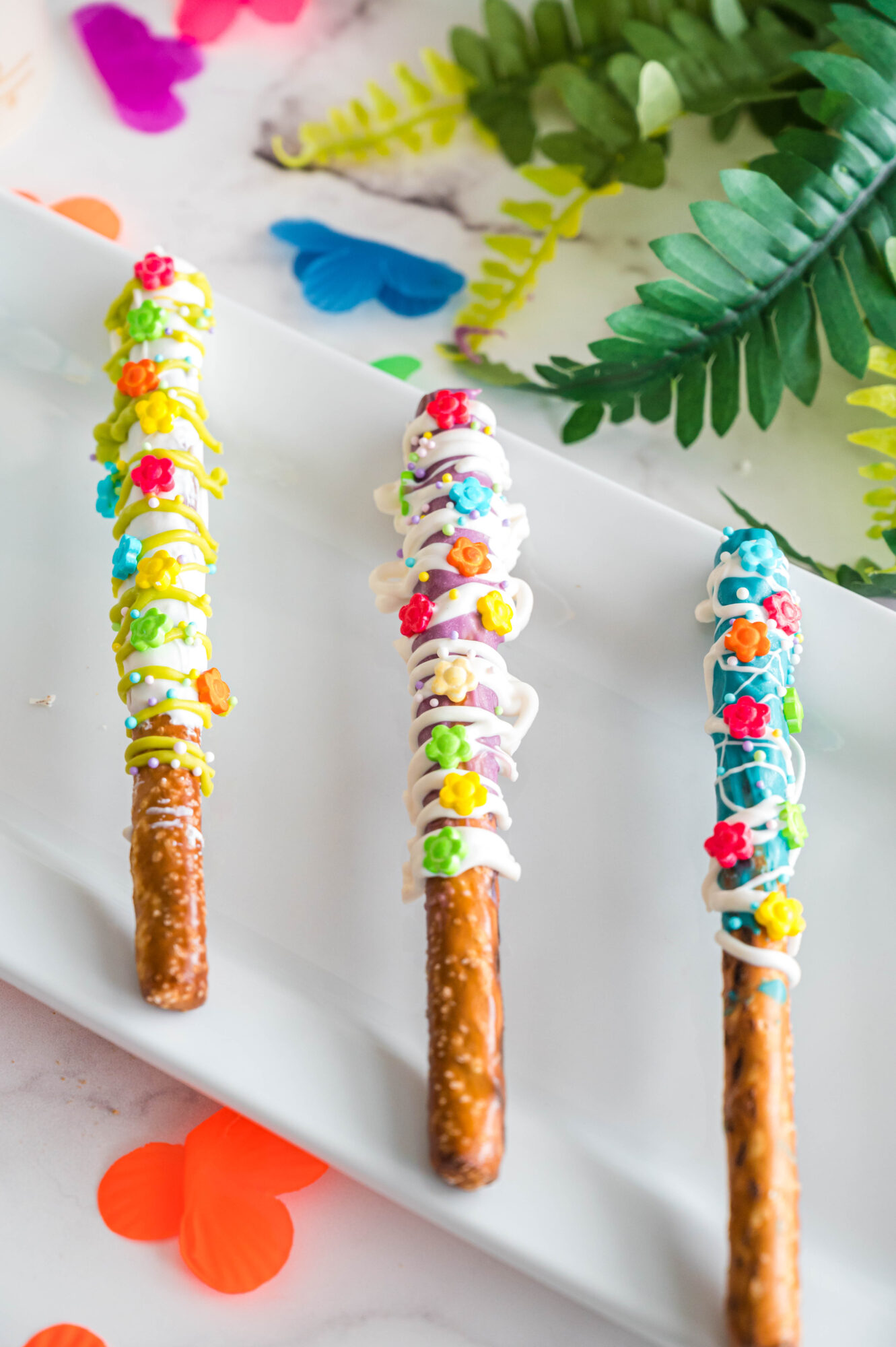 encanto chocolate dipped pretzel rods on table