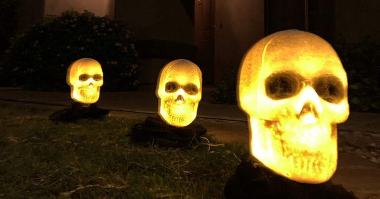 These Light Up Skeleton Heads Are the Perfect Decor to Place Alongside Your Driveway for Spooky Season